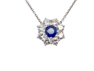 beautiful new 18 carat white gold cluster pendant, showcasing a sapphire at its centre.