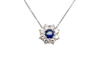 beautiful new 18 carat white gold cluster pendant, showcasing a vibrant blue sapphire at its centre.