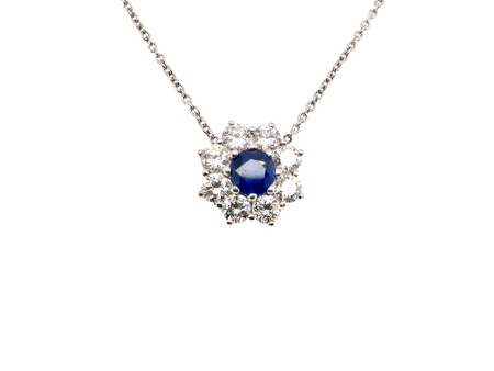 beautiful new 18 carat white gold cluster pendant, showcasing a vibrant blue sapphire at its centre.