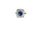 beautiful original Art Deco cluster ring featuring a rich, dark blue oval-cut sapphire