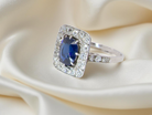 beautiful original Art Deco cluster ring featuring a rich, dark blue oval-cut sapphire side