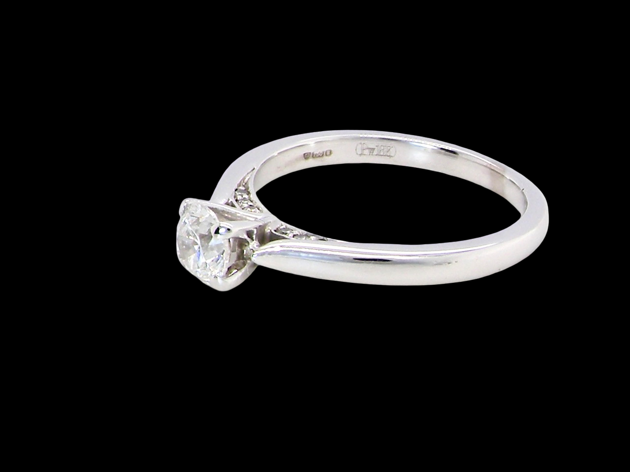  beautifully crafted solitaire ring featuring a brilliant-cut white diamond  A