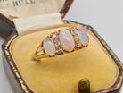 boxed A beautiful Victorian dress ring, set with three finely matched oval opals, 