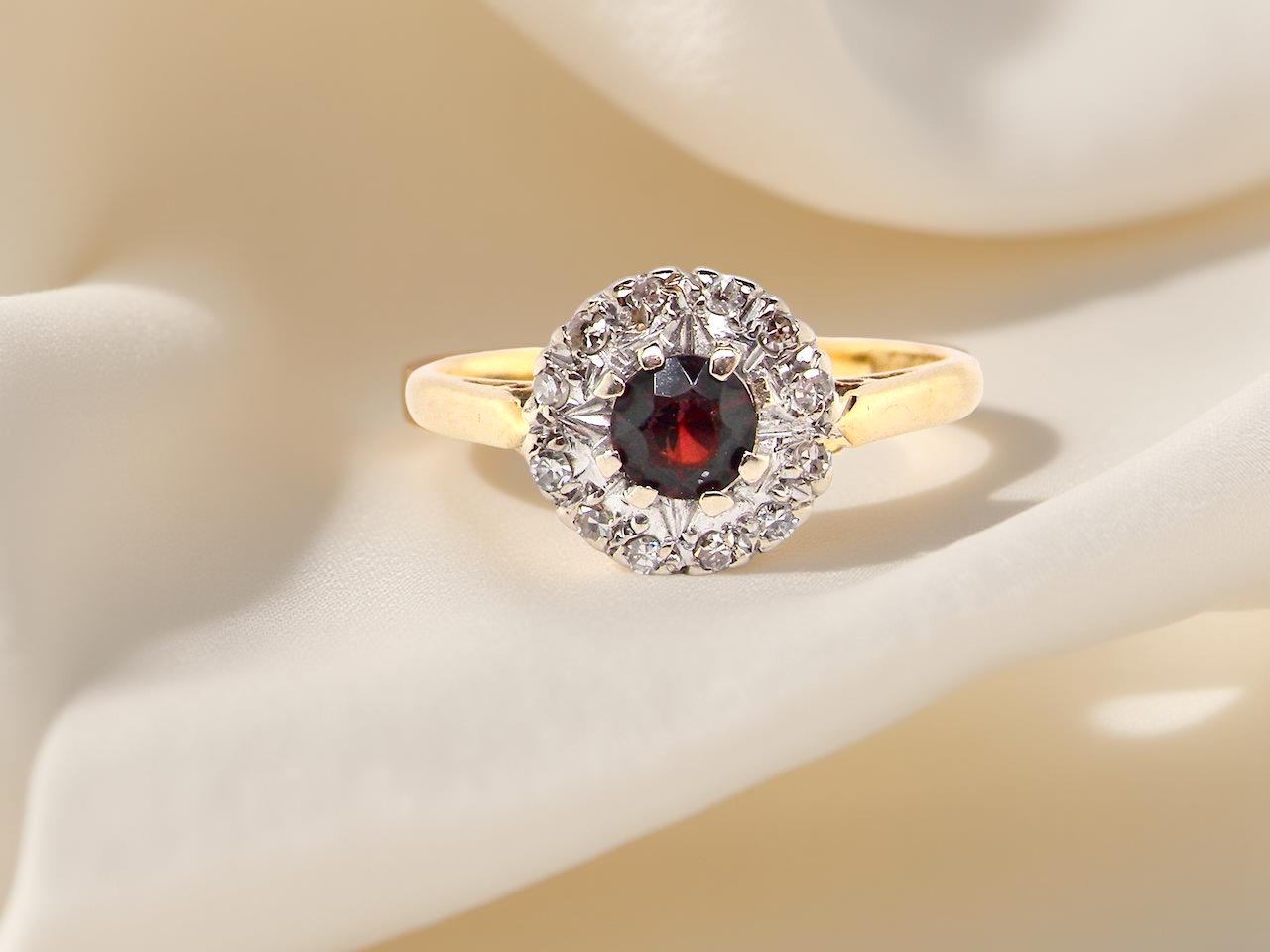  classic 1960s 18 carat yellow gold cluster ring, featuring a garnet 