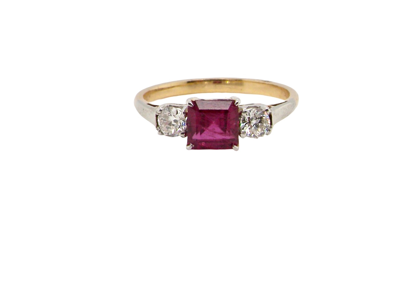 Gold ring with a red gemstone and two smaller diamonds on a white background