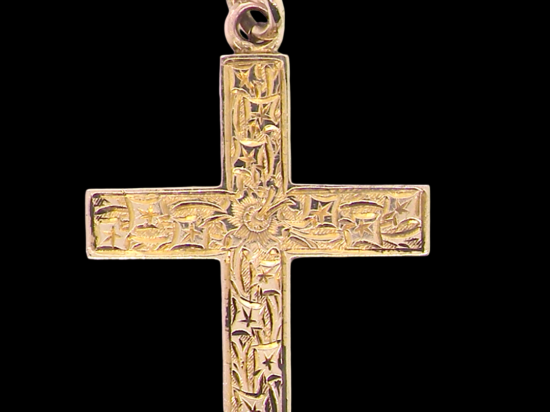 close view A fine 9 carat gold cross. Hand engrarved across the whole body of the cross which measures 45x25mm
