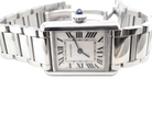 close view A womans stainless steel Cartier Tank Must wrist watch. Model number WSTA0051.

Silver coloured dial with Roman Numerals. Blue steeled hands. Case measures 29.5x22mm, case thickness 6.6mm. Quartz movement, synthetic sapphire button.
