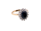  cluster ring featuring a deep ink-black blue sapphire 