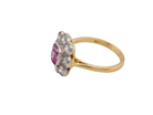  A cluster ring featuring a beautiful cushion-cut pink sapphire  side