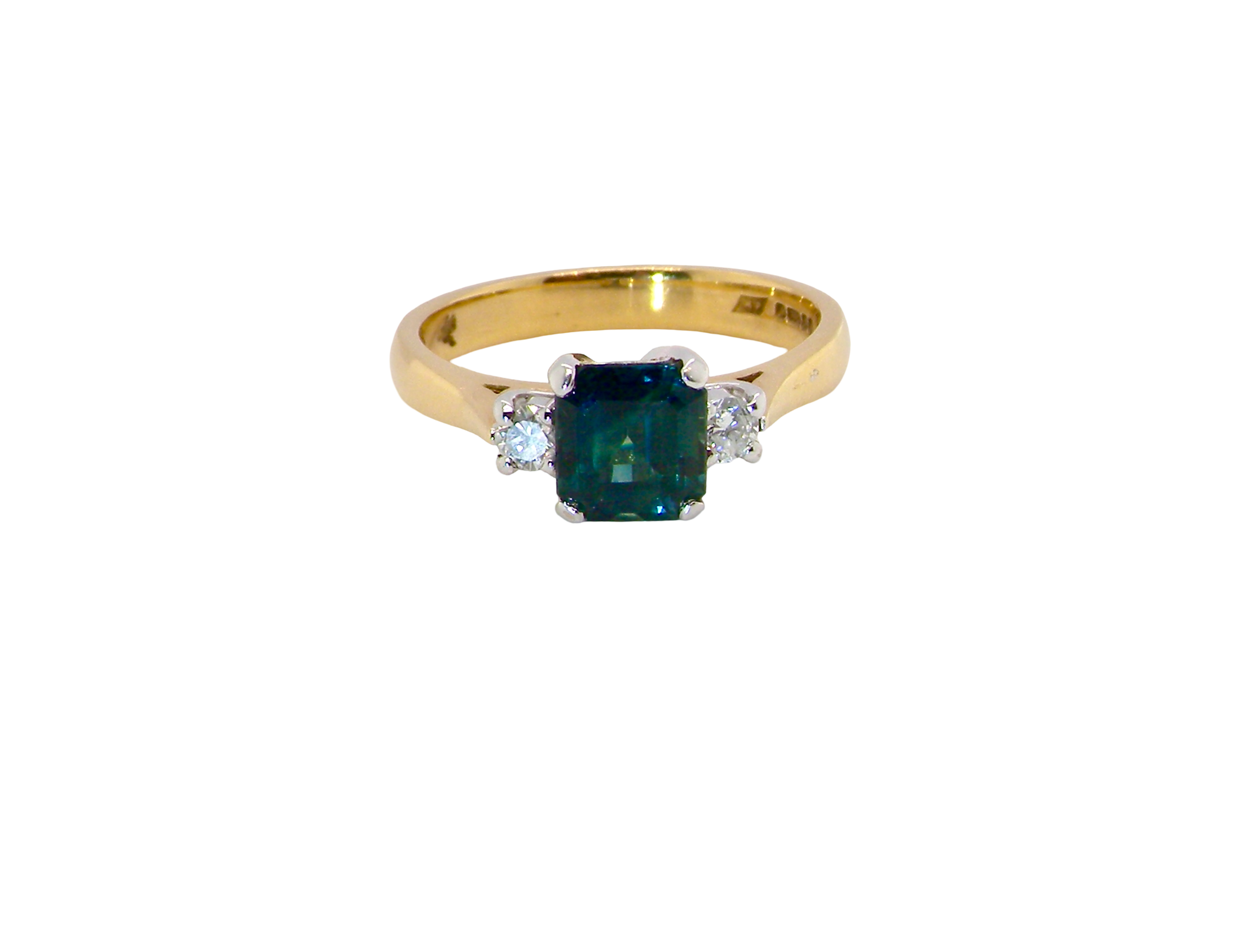 elegant 18 carat yellow gold trilogy ring featuring a striking natural sapphire at its centre