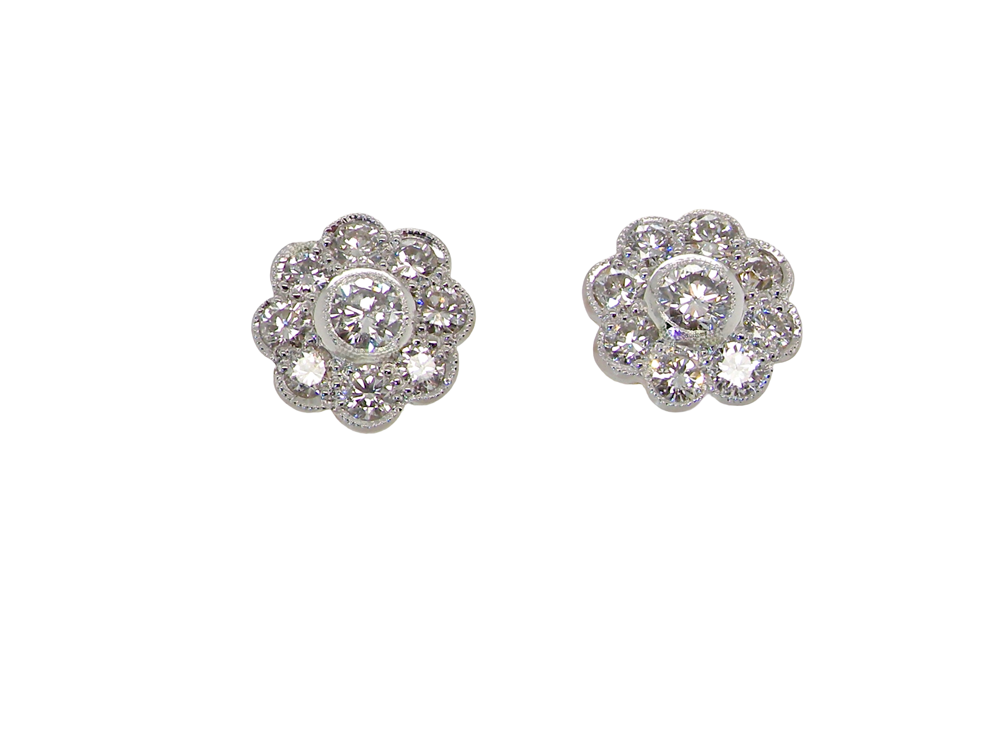 elegant pair of 18 carat gold* cluster earrings, each beautifully set with brilliant-cut white diamonds.