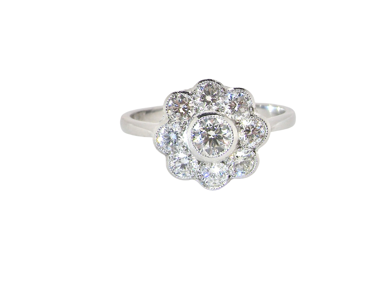 elegant vintage cluster ring crafted in platinum* and set with a diamond centre stone,