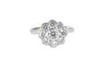 elegant vintage cluster ring crafted in platinum* and set with a diamond centre stone,