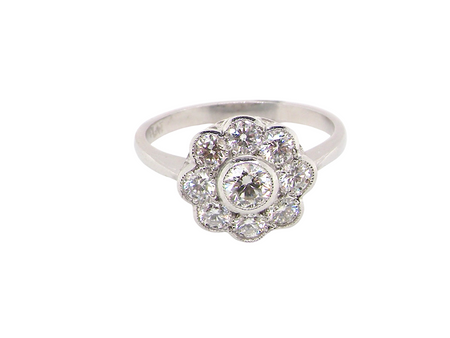 elegant vintage cluster ring crafted in platinum* and set with a diamond centre stone,&nbsp;0.25ct