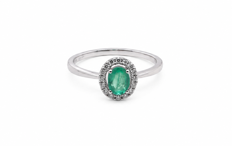 white gold ring with a green gemstone on a white background
