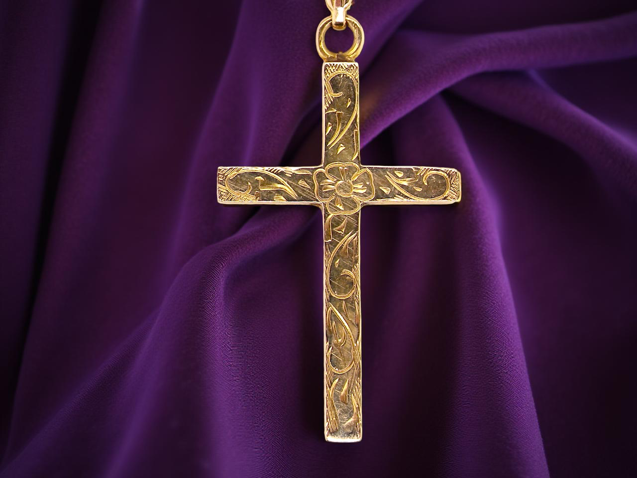 An engraved 9 carat gold cross