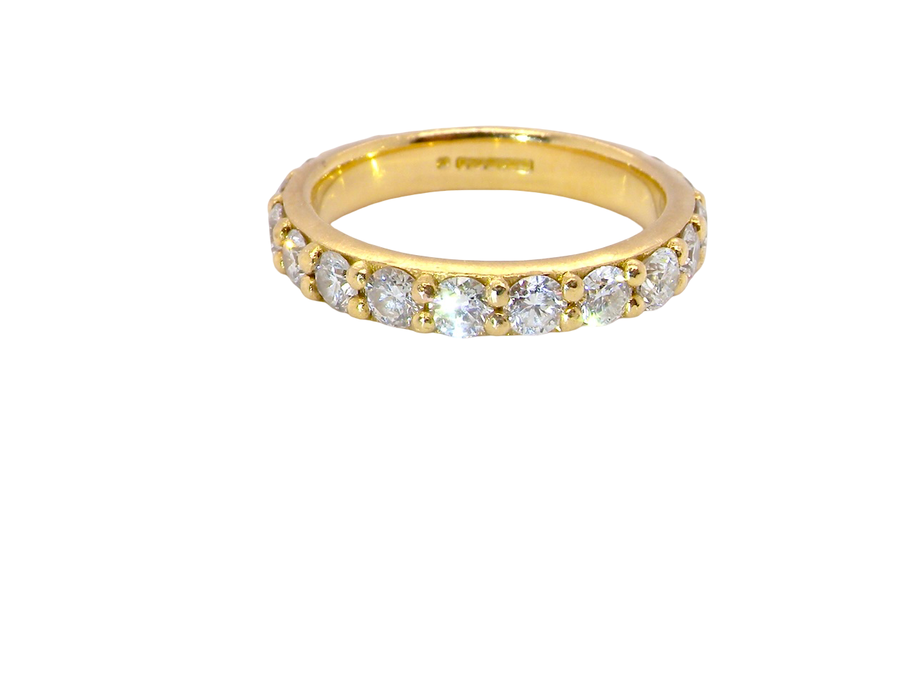 eternity ring is 18ct gold and set with fourteen round brilliant-cut white diamonds.