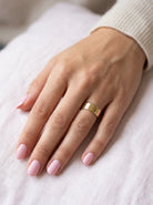 female hand A wide wedding ring 8mm, with a flat profile (not D shape) . Totally plain and re-polished to near perfect condition.