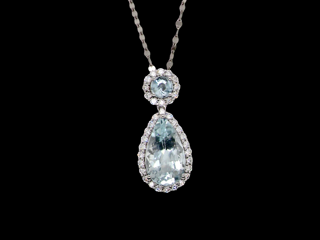 Teardrop-shaped gemstone necklace on a black background