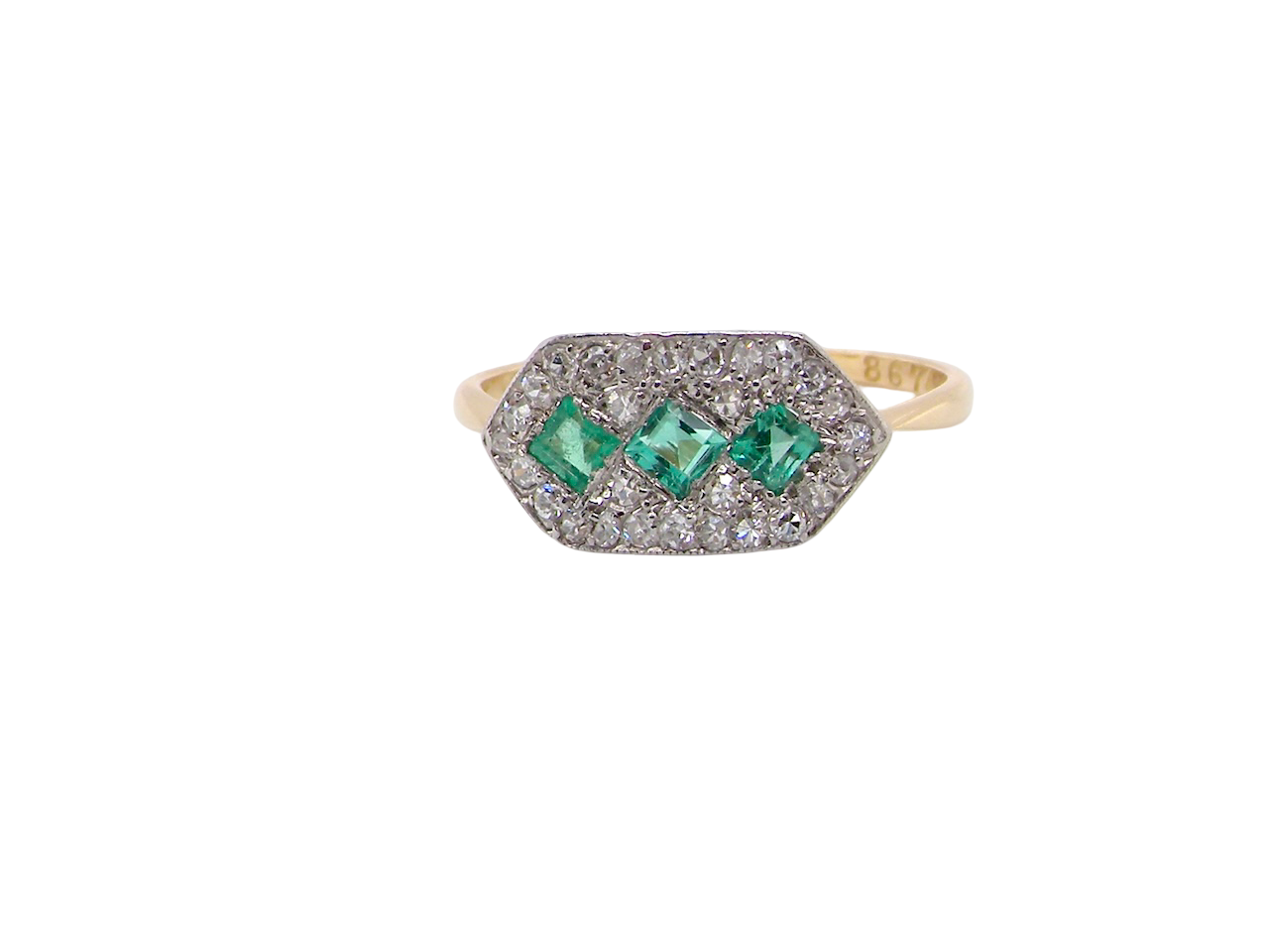  fine Edwardian era cluster ring, beautifully handcrafted with a trio of vibrant emeralds surrounded by a halo of antique old-cut diamonds. 
