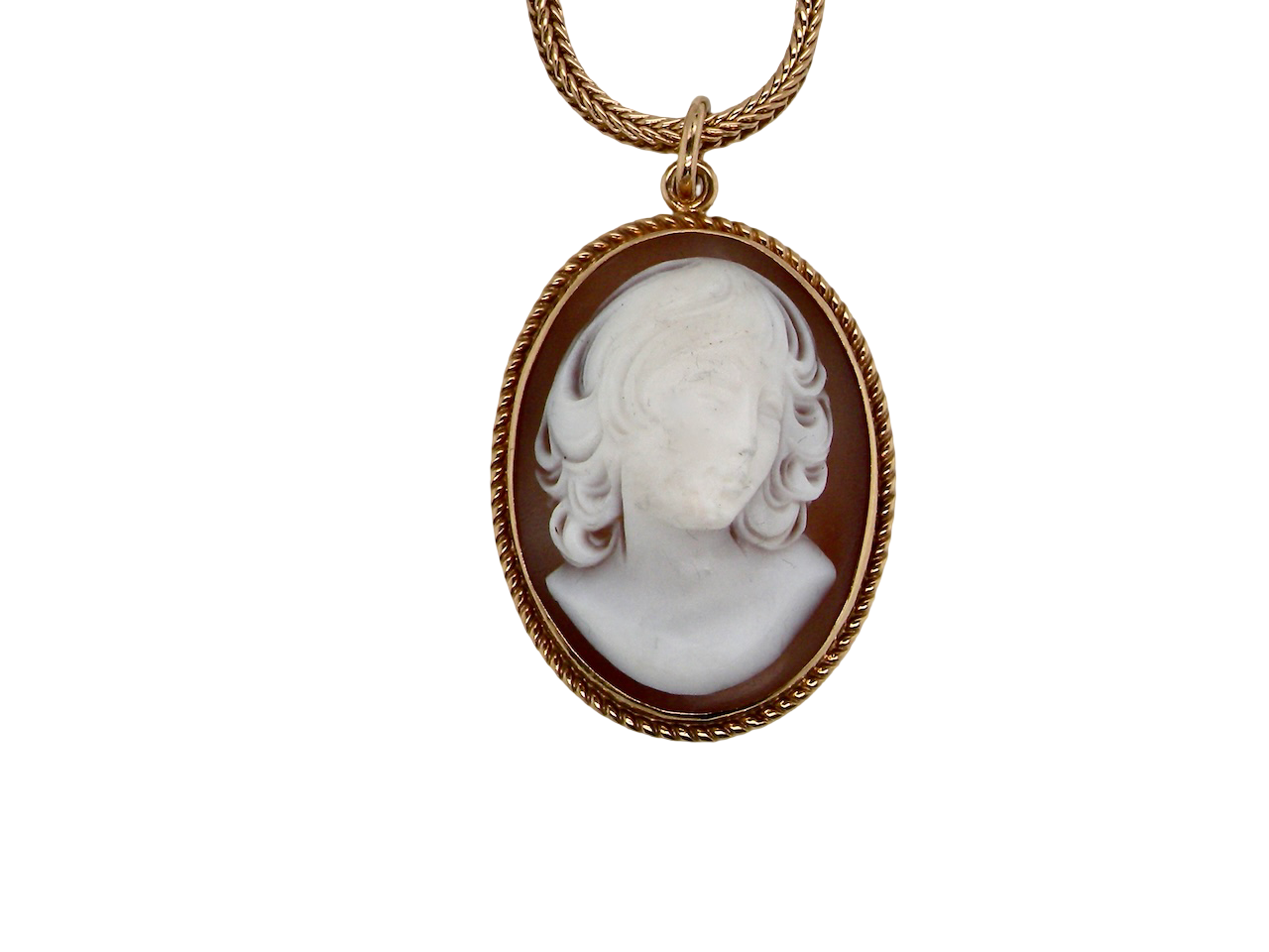 Cameo pendant with a gold frame on a white background