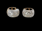 A fine pair of cuff style hoop earrings. The front part is 18 carat white gold * set with seven small white diamonds, 