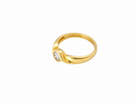 A yellow gold ring with a small marquise-cut clear gemstone, shown on a plain white background.