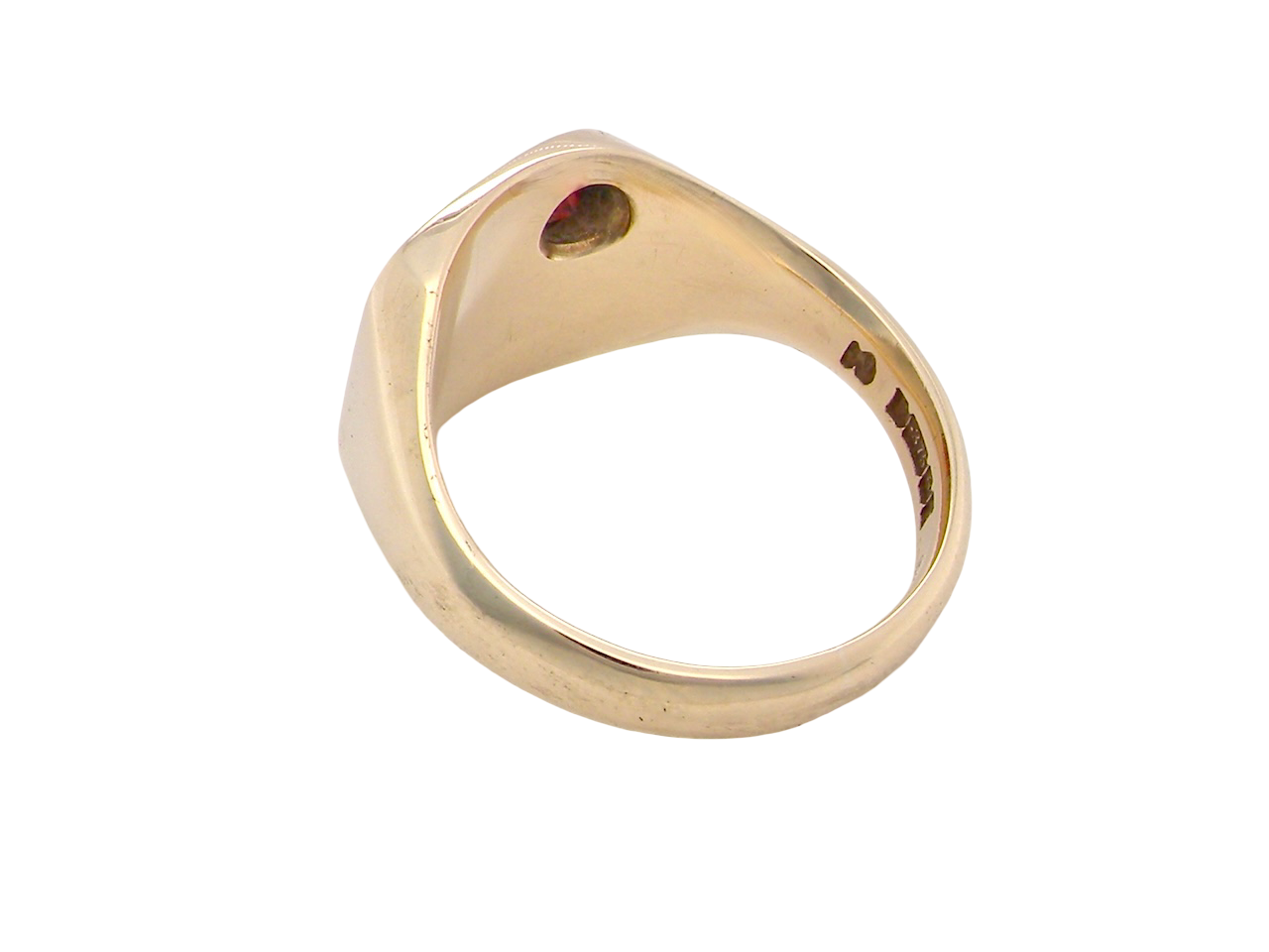 Gold ring with a red gemstone on a white background