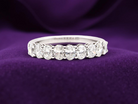gorgeous half-hoop eternity ring set with 9 oval brilliant-cut white diamonds.