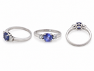 group An 18 carat white gold three stone ring. Centre stone a round tanzanite 6mm diameter.
Each side a brilliant cut white diamond