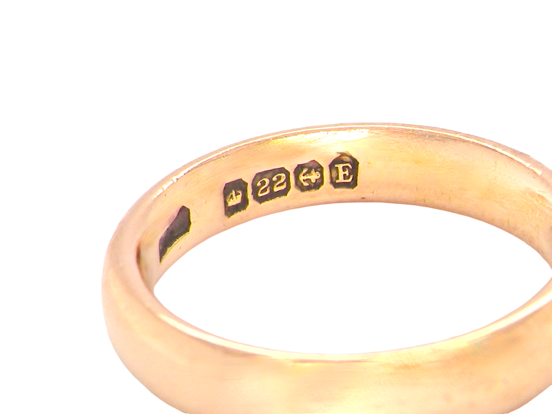 hallmarks wedding ring is 22 carat gold, just 2 points off pure.

3.6mm width, 1.9mm depth, weight 5.2grams. A lovely deep gold colour and patina.