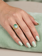 hand A pretty dress ring. Set with a cabouchon cut banded green agate , colours from jade green with stripes down to the base turning to white.
