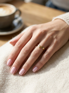 hand A 9 carat gold wishbone shaped ring. Can be worn as a statement piece or as a wedding ring.
