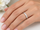 hand A 9 carat white gold wedding ring. Set with three invisbly set diamonds, each 1.5mm (0.015 carats each).