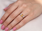 hand A beautiful 18 carat yellow gold trilogy ring, combining the warm golden tones of a yellow sapphire with&nbsp; white diamonds.