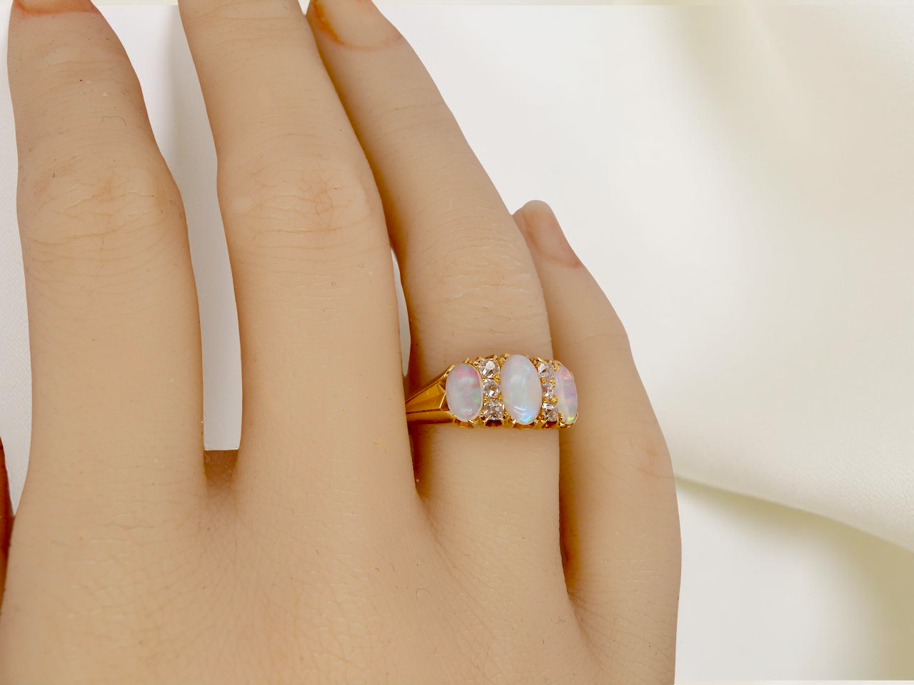 hand A beautiful Victorian dress ring, set with three finely matched oval opals, 