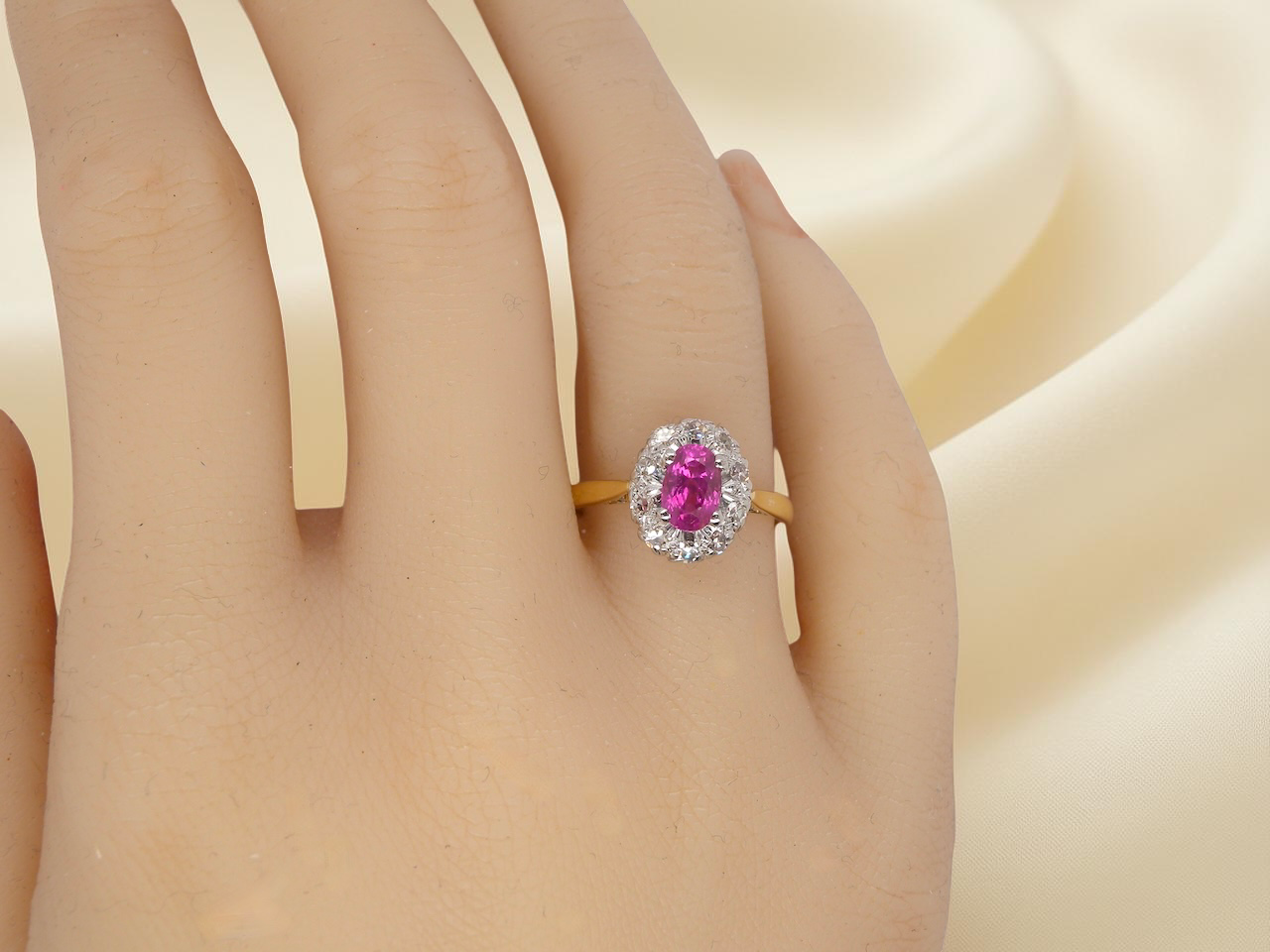 hand A beautiful vintage cluster ring showcasing a vivid pink sapphire centre stone, measuring approximately 6.6 × 4.3 mm(estimated 0.65 carats).