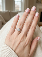 hand A beautiful vintage diamond cluster ring, elegantly set with seven brilliant-cut white diamonds in a timeless floral cluster design.