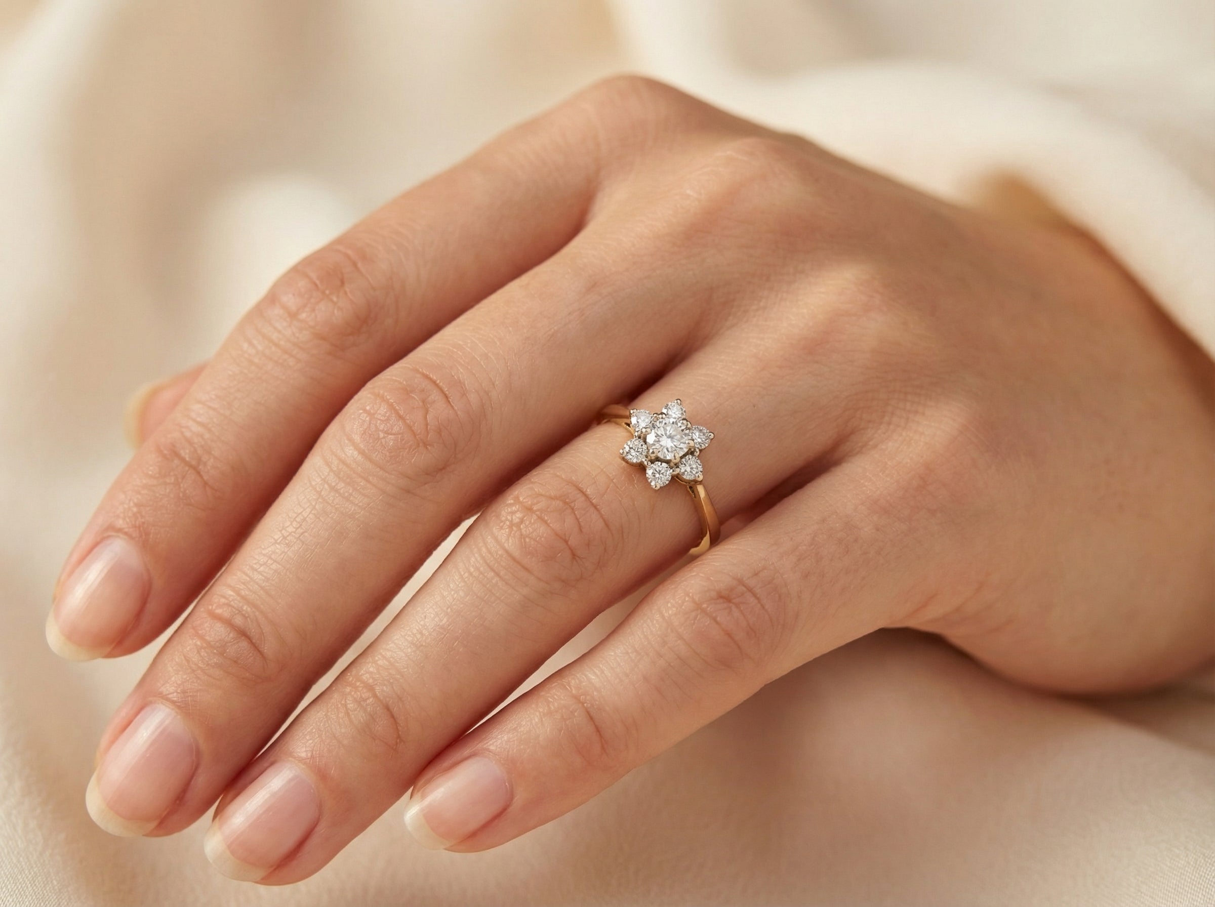 hand A beautifully crafted vintage diamond cluster ring, dating to the 1960s, featuring a classic floral-inspired design that remains timeless and elegant.