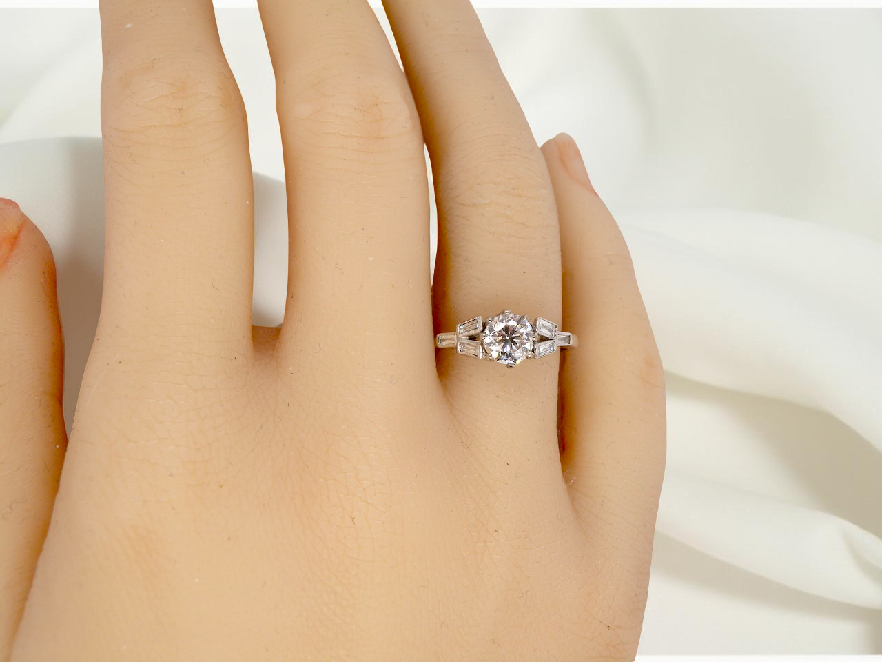 hand A beautifully proportioned Art Deco solitaire ring showcasing a sparkling old brilliant cut white diamond