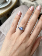 hand A fine platinum* ring. Features a lovely sky blue sapphire with 'star sapphire ' chatoyancy , measures 10x9mm, (est 4 carats) held by four claws, cabouchon cut