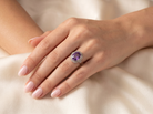 hand A fine vintage ring. Features to the centre a large cushion shaped amethyst, 13x10mm, rim setting.
