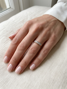 hand A fine vintage ring set with five brilliant cut white diamonds.&nbsp;

Centre diamond 3.6mm (est 0.15 carats) 