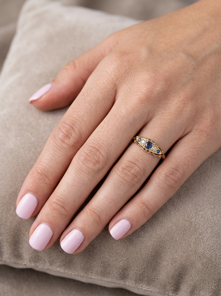 hand A lovely antique ring from the Edwardian period. Hallmarked in Chester in 1909 this ring typical for the period is set with sapphires and diamonds.
