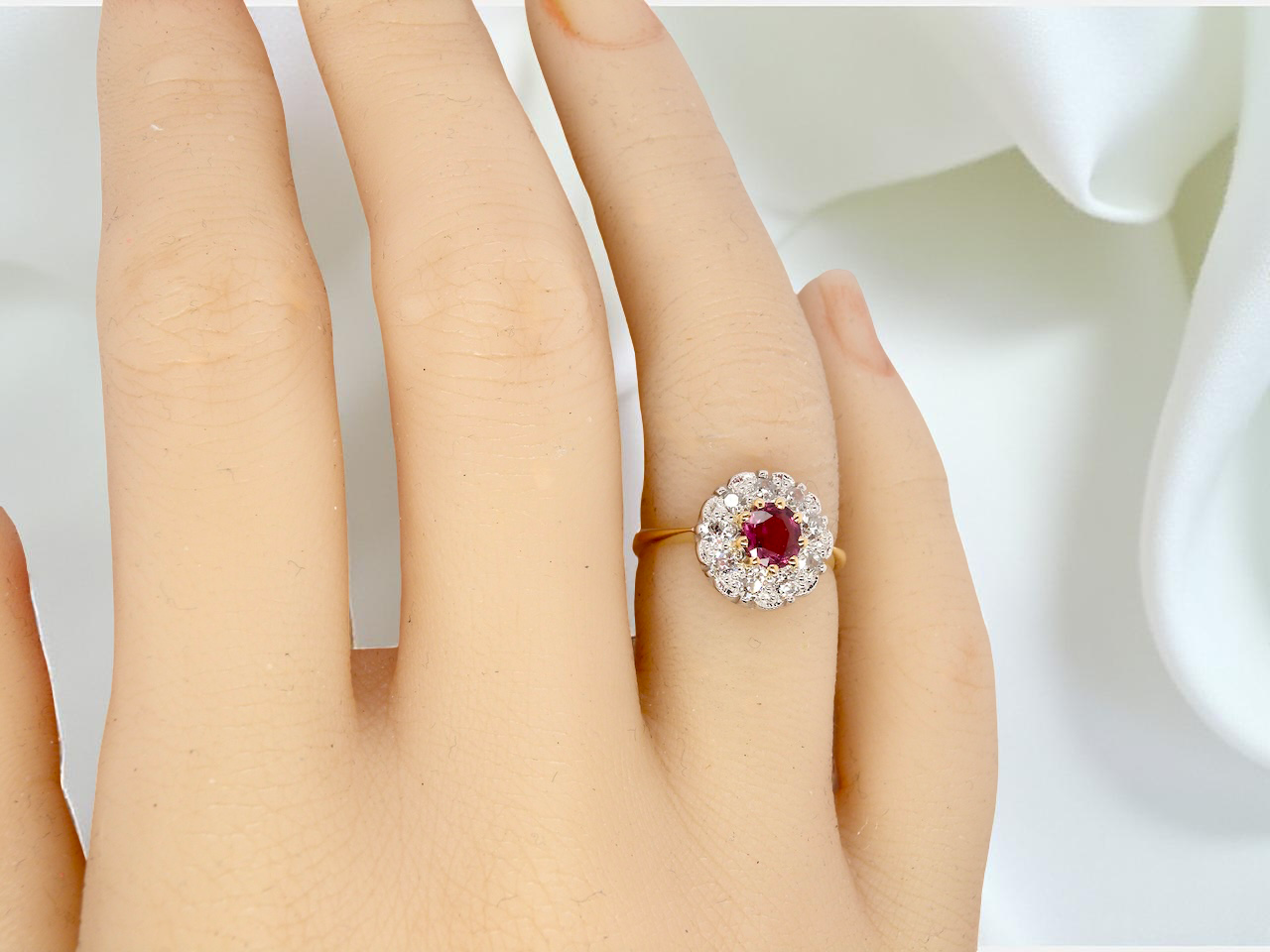 hand A lovely daisy cluster ring that profiles to the centre a deep red ruby, 5mm (0.50 carats) yellow claw set.
