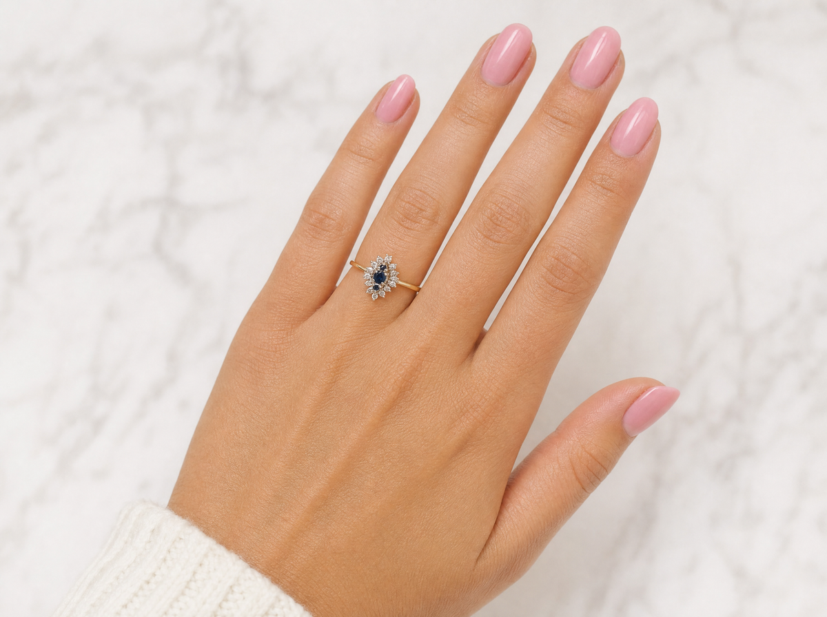 hand A navette shaped cluster ring. The centre a line of three sapphires, 0ne x 3.5mm, 2 x 1.5mm.
