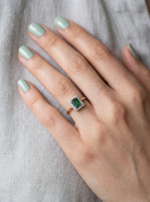 hand A near new cluster ring that shows no sign of wear, seems unworn.

Features a deep mint green tourmaline gemstone, 