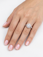 hand A new diamond cluster ring* An oval diamond halo cluster ring. Set with brilliant cut white diamonds, colour H-k, clarity Si.