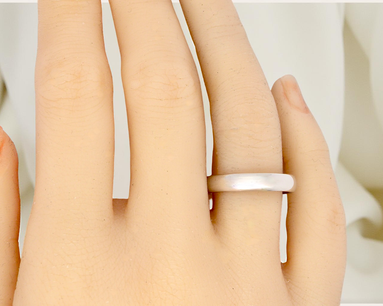 A plain 18 carat white gold wedding ring