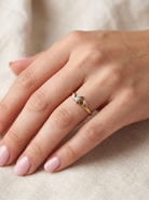 hand A pretty diamond solitaire ring. The diamond 2mm (0.03 carats) and illusion set in platinum.&nbsp; Head overall 4.3mm.